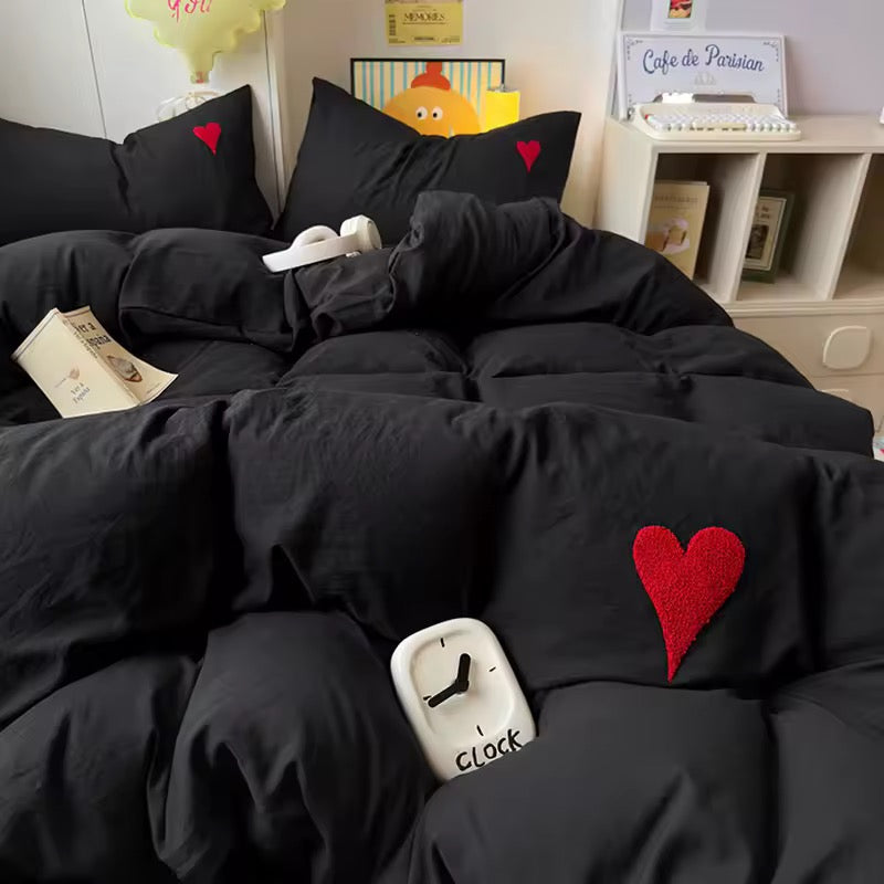 Cozy black comforter with red heart embroidery in an aesthetic dorm setup