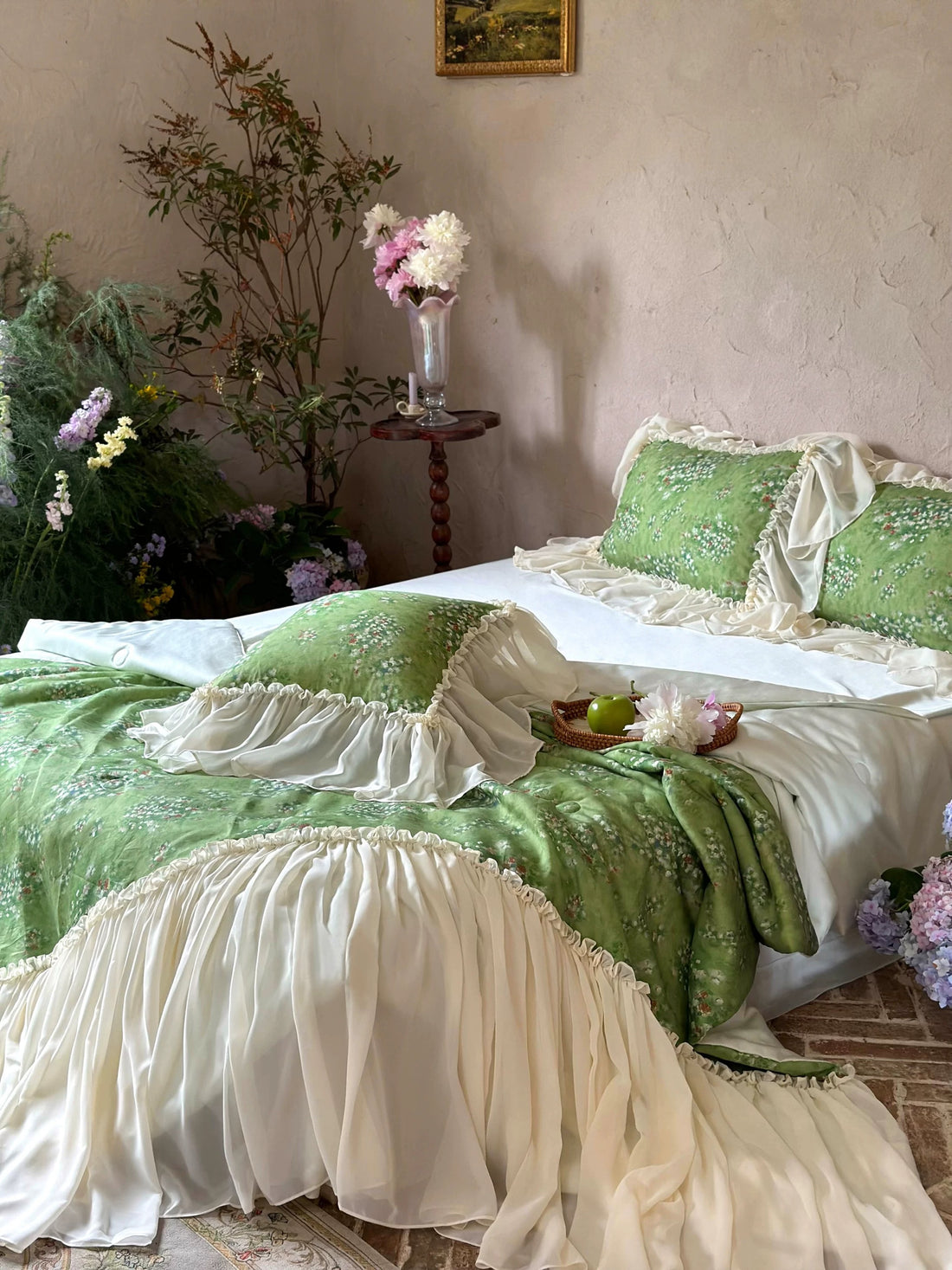 Green and white bedspread on a bed in a room with decorative elements.