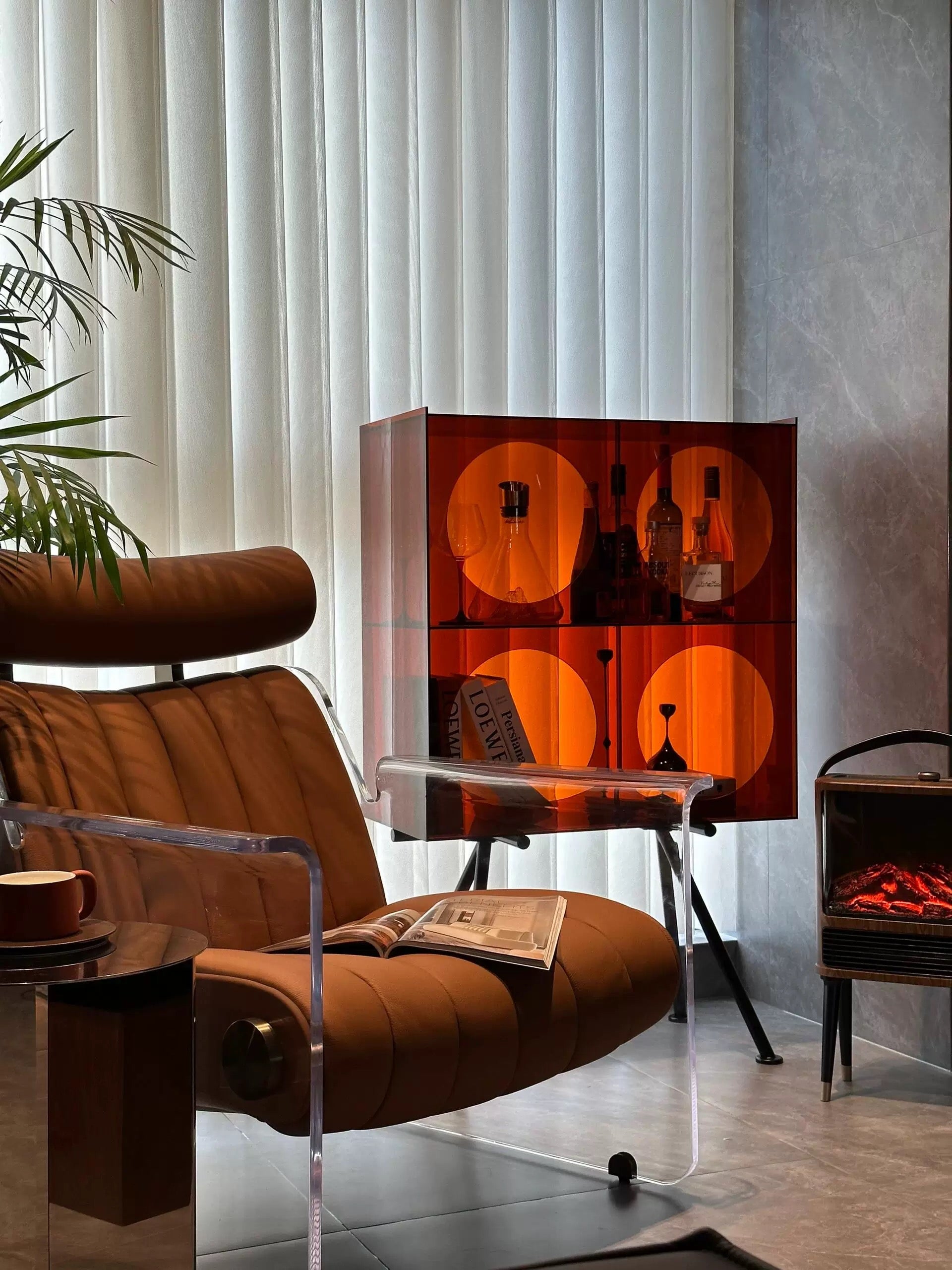 Modern living room with a brown armchair, glass cabinet, and decorative elements.