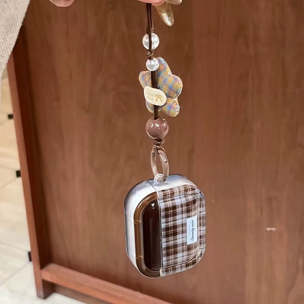 Plaid keychain with decorative beads on a wooden surface