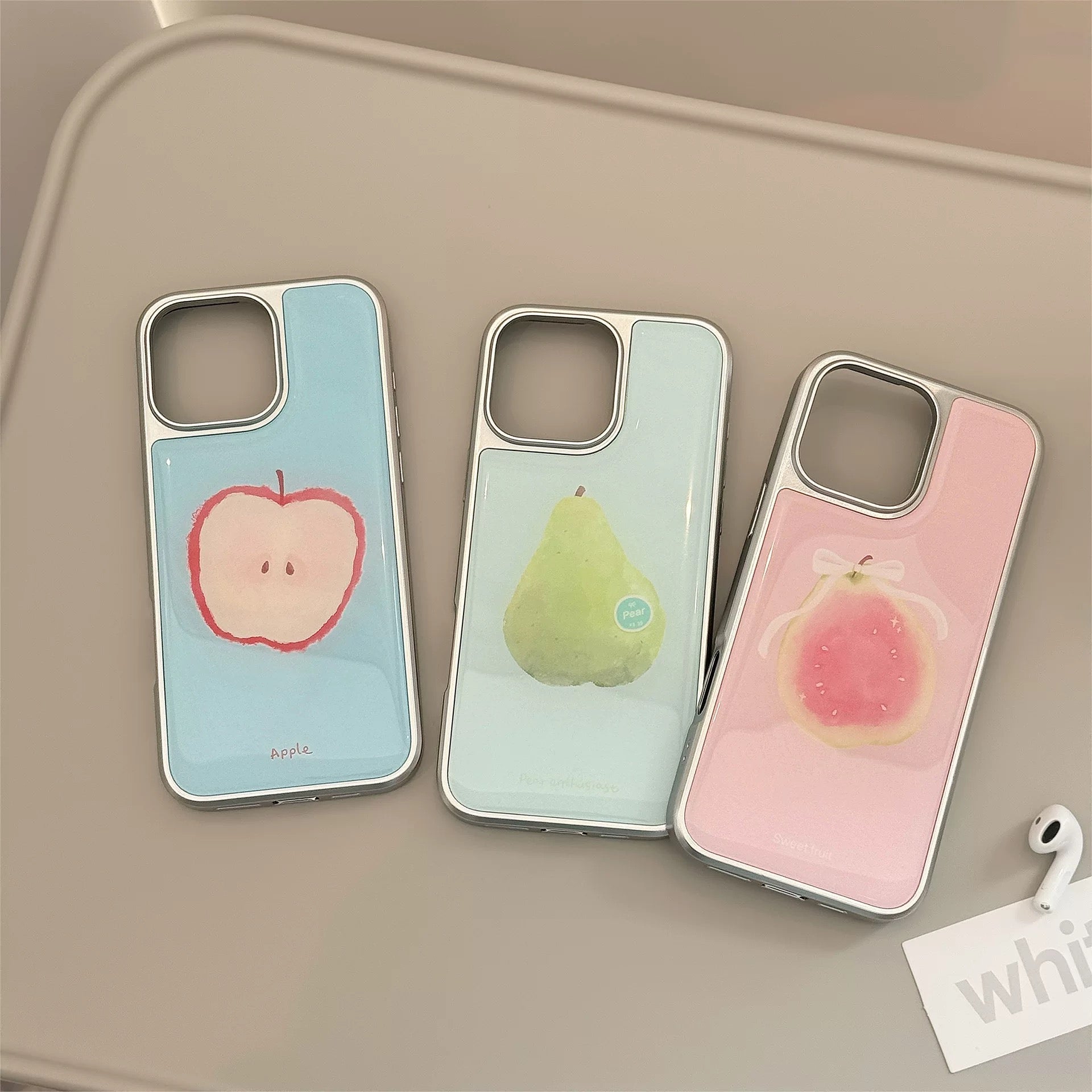 Hand holding pastel guava iPhone case with glossy finish and soft girl nail art – TikTok vibe.