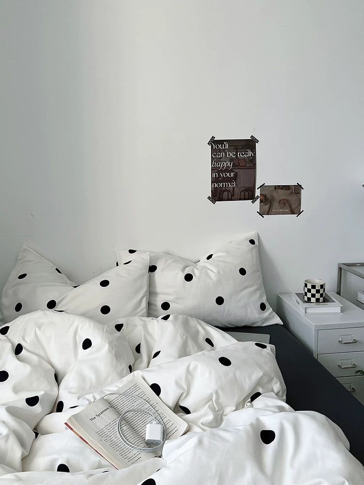 Bed with polka dot bedding in a bedroom setting