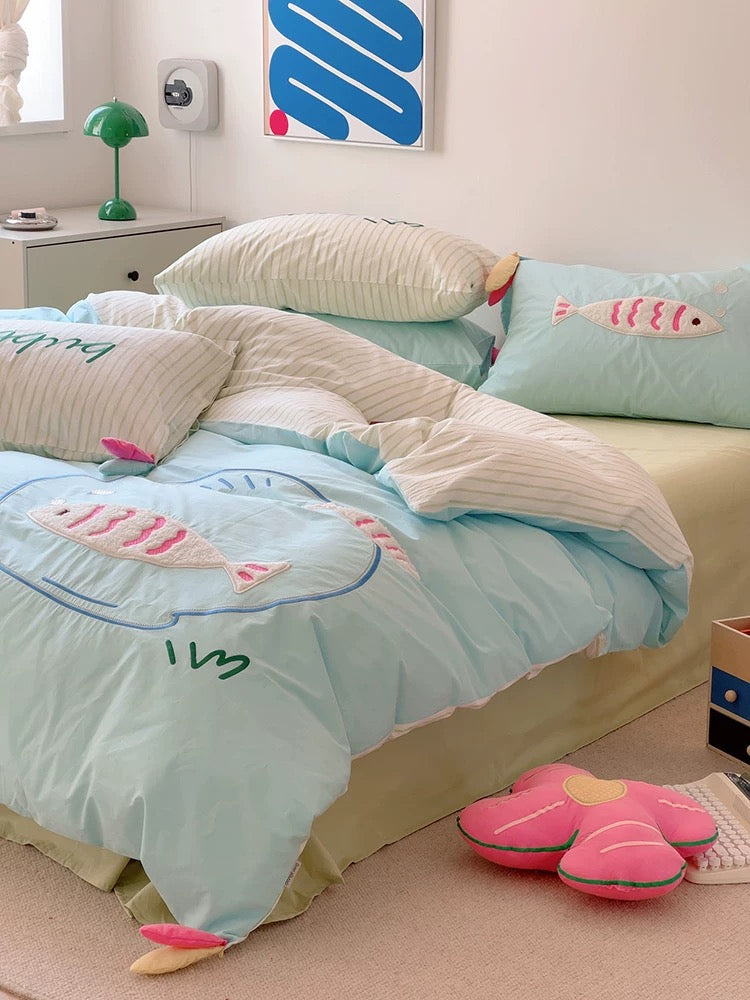 Cozy dorm bed with kawaii blue bedding and striped accent pillow, perfect for dopamine decor.