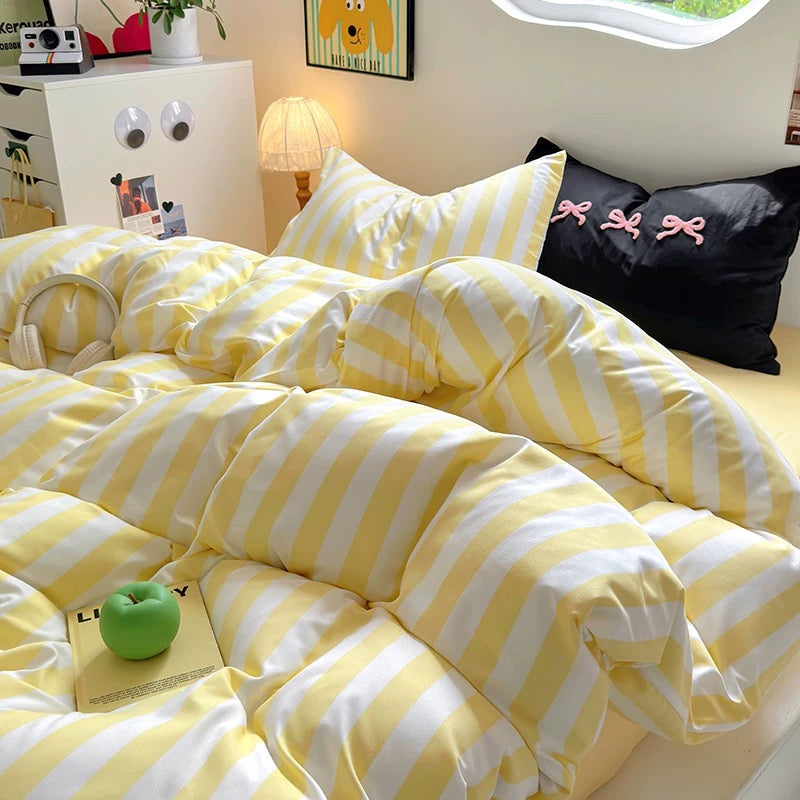Soft girl themed bedroom highlighting the pastel yellow bedding set and matching accessories.