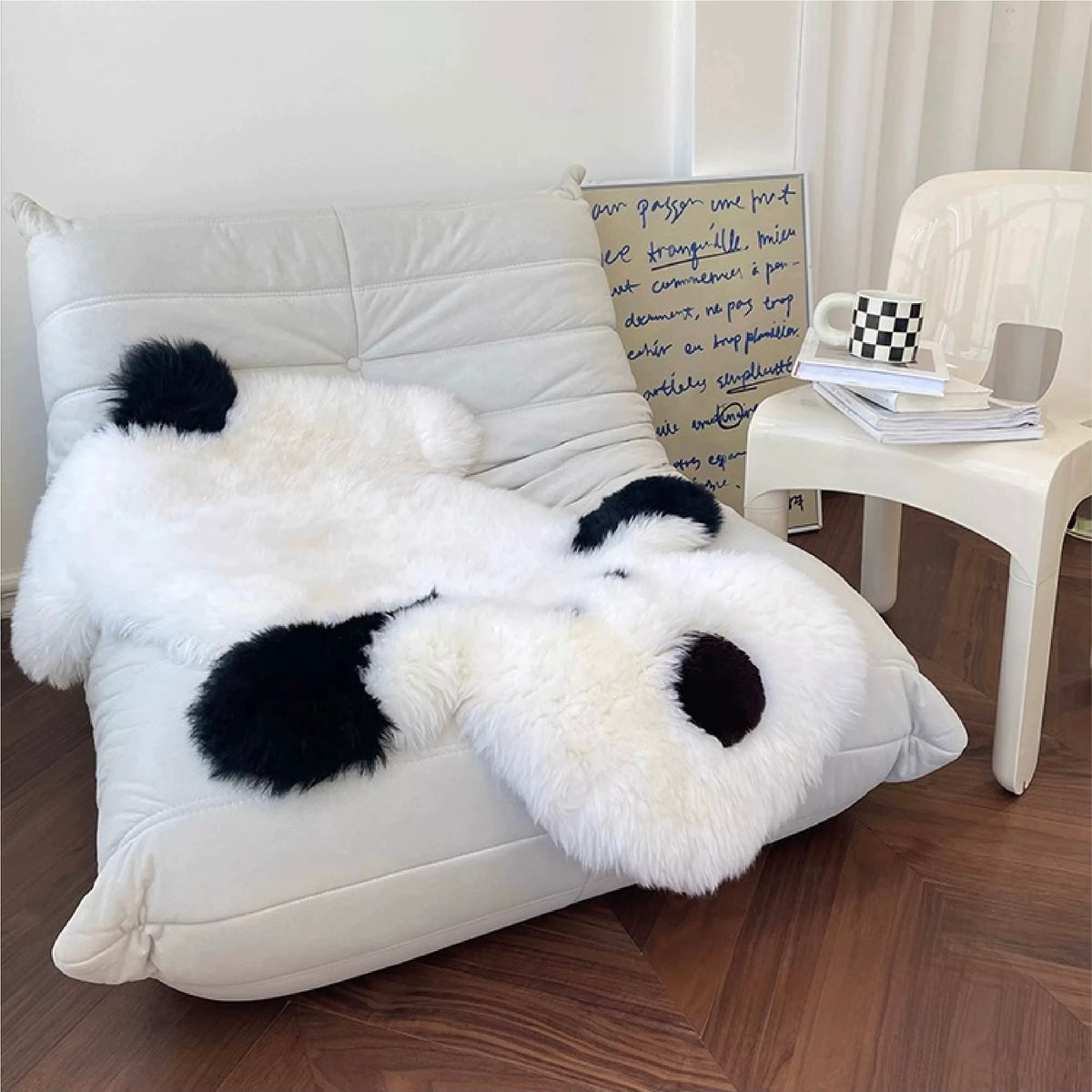A white animal shaped rug stretches across a lounge chair, with its dog face draped over the front edge.