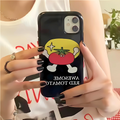Person holding a phone with a cartoon tomato design on a black case.