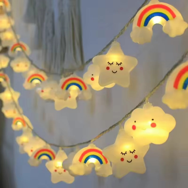 String lights with cloud and rainbow designs on a plain background