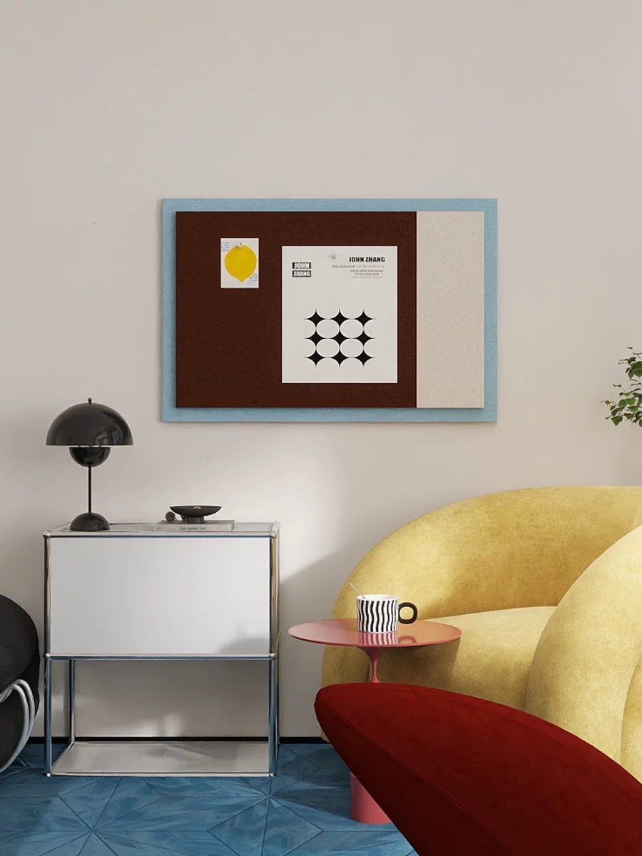 Bauhaus color block pin board displayed above a desk with a yellow sofa
