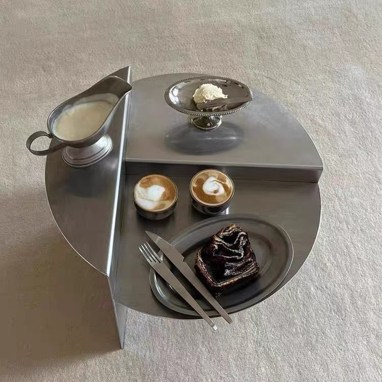 Bauhaus stainless steel coffee table featuring sculptural round design for modern minimalist living room interior styling today.