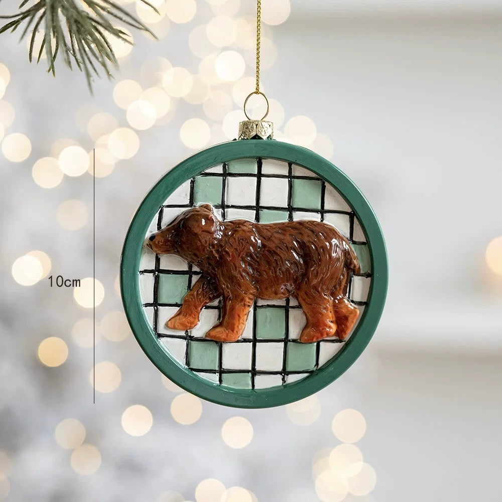 A bear Christmas ornament has a raised brown bear on a green and white checked circle with a green rim.