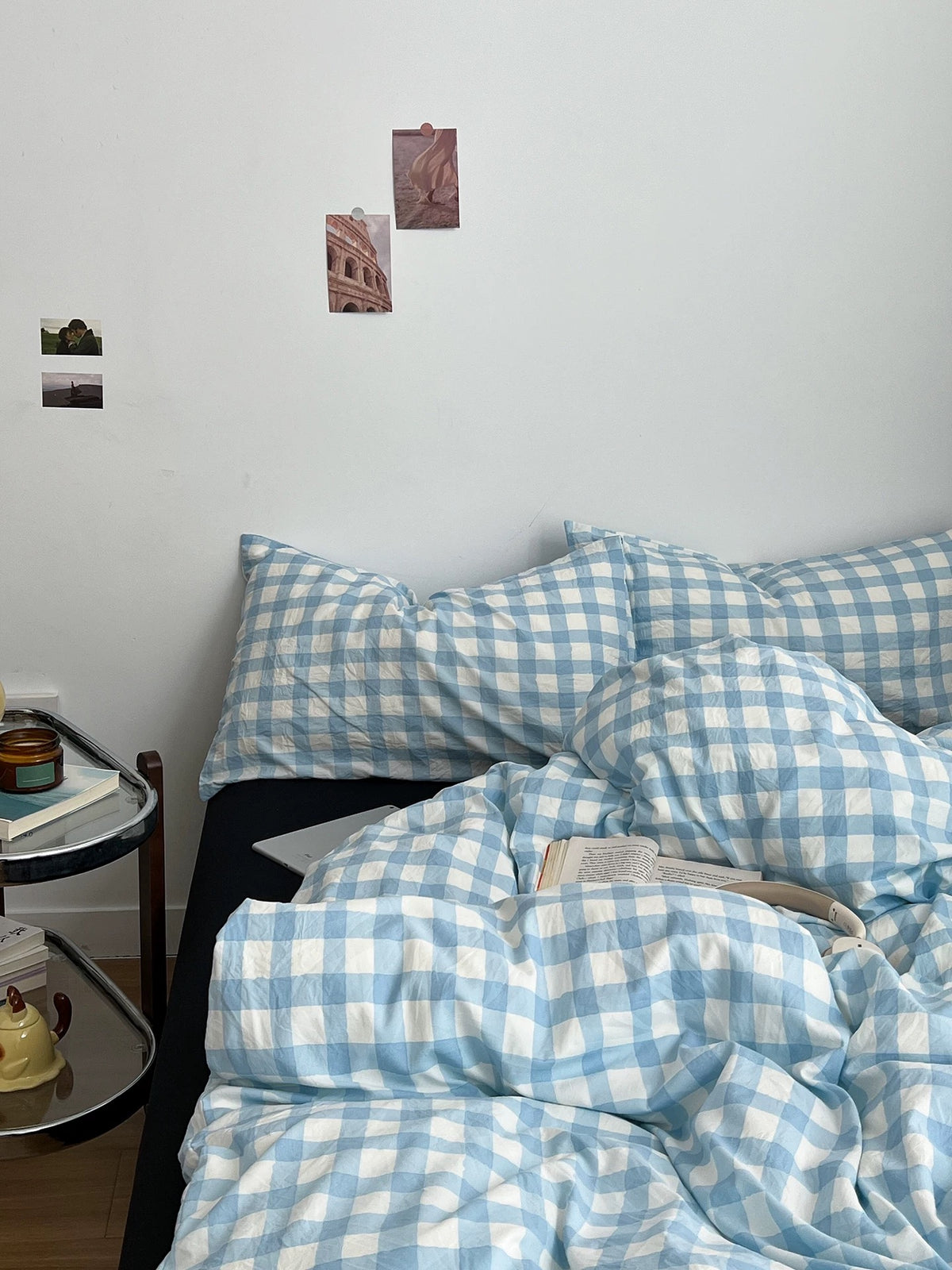 Black and blue checkered bedding on a styled bed with simple bedroom decor
