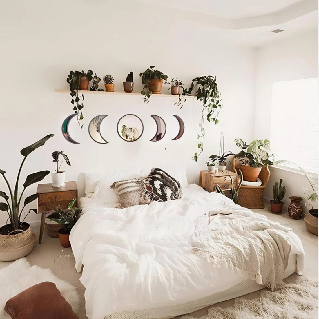 Beige moon mirrors arranged in lunar order above a cozy bed with fairy lights