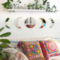 Moon phase wall mirror set with wooden base in black color, styled on a neutral wall