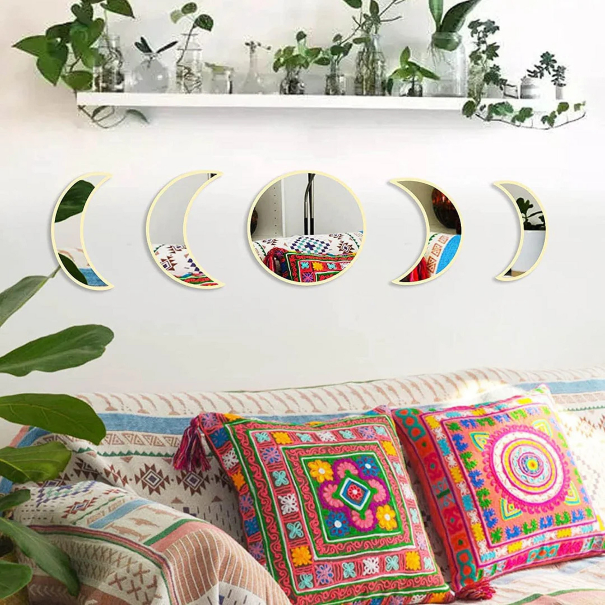 Moon phase wall mirror set with wooden base in black color, styled on a neutral wall