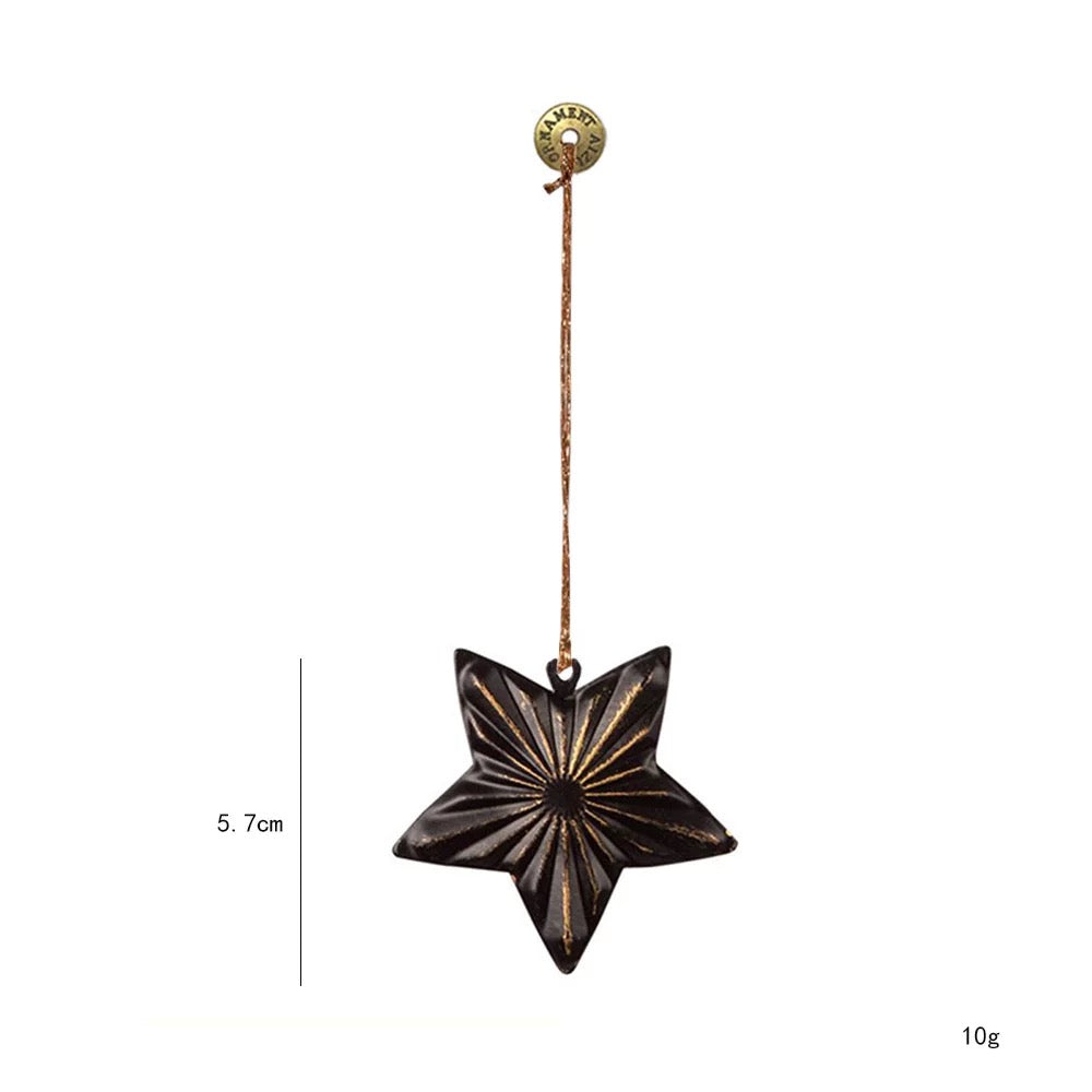 A black star metal Christmas ornament has raised pointed sections with gold colored lines across its face.