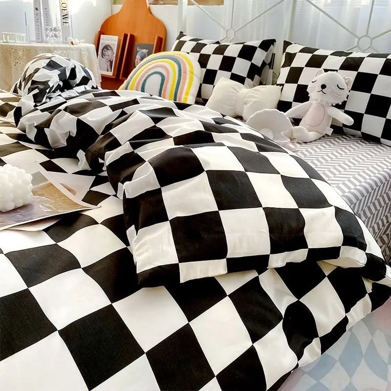 Black and white checkerboard bedding set styled on a bed with matching pillowcases