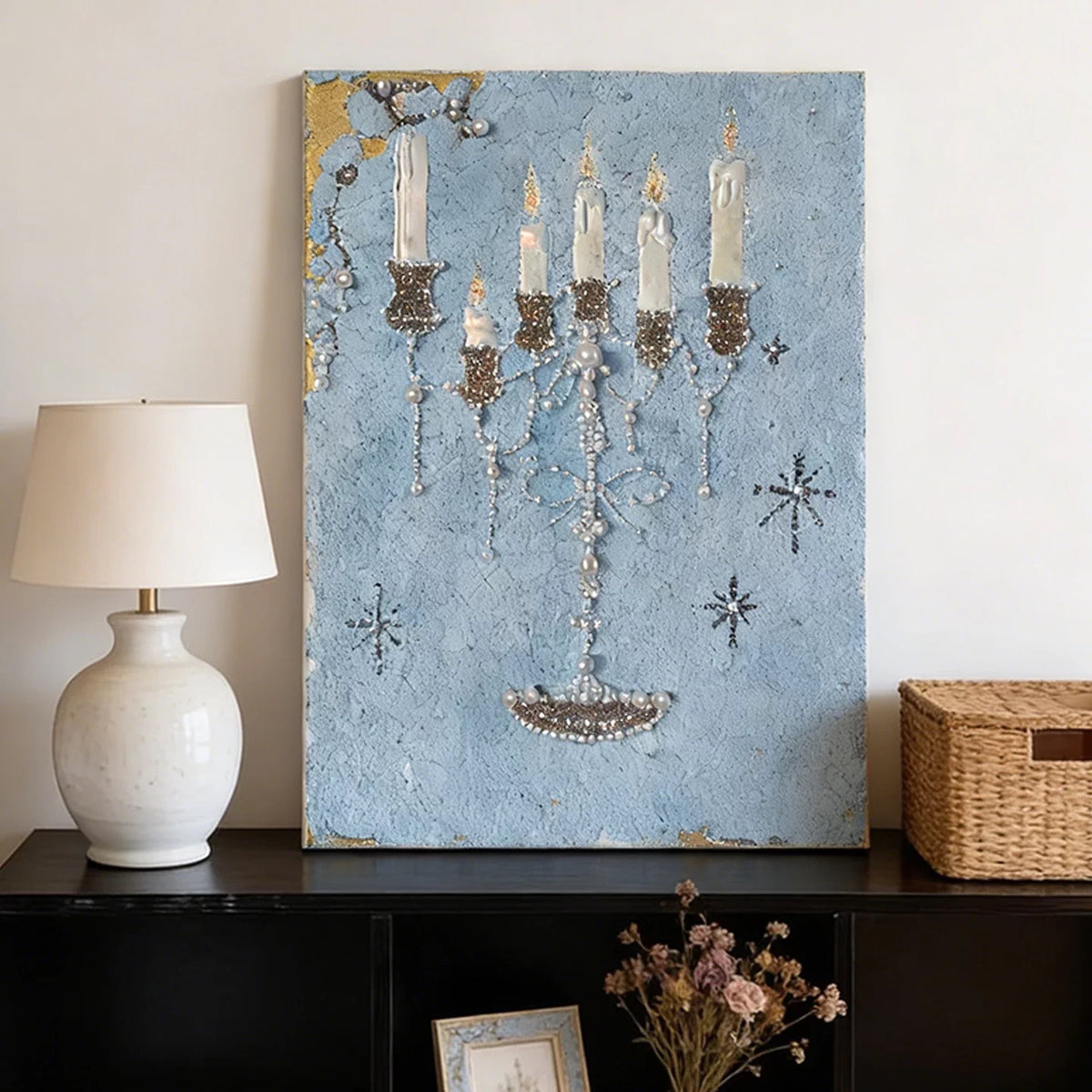 Blue candelabra canvas print styled with a white lamp and woven storage basket