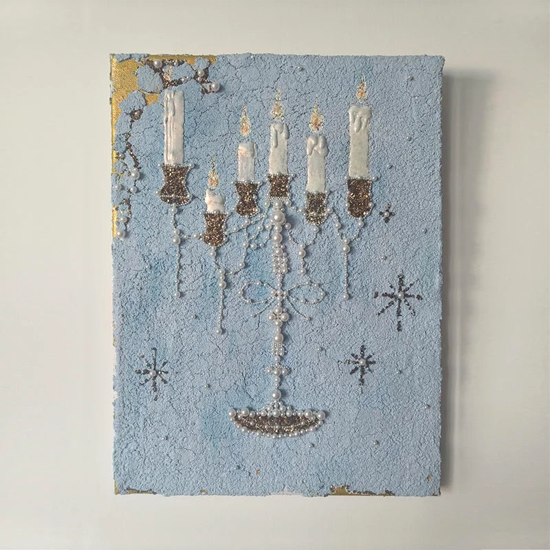 Blue candle canvas print with pearl-like printed strands and a bow motif
