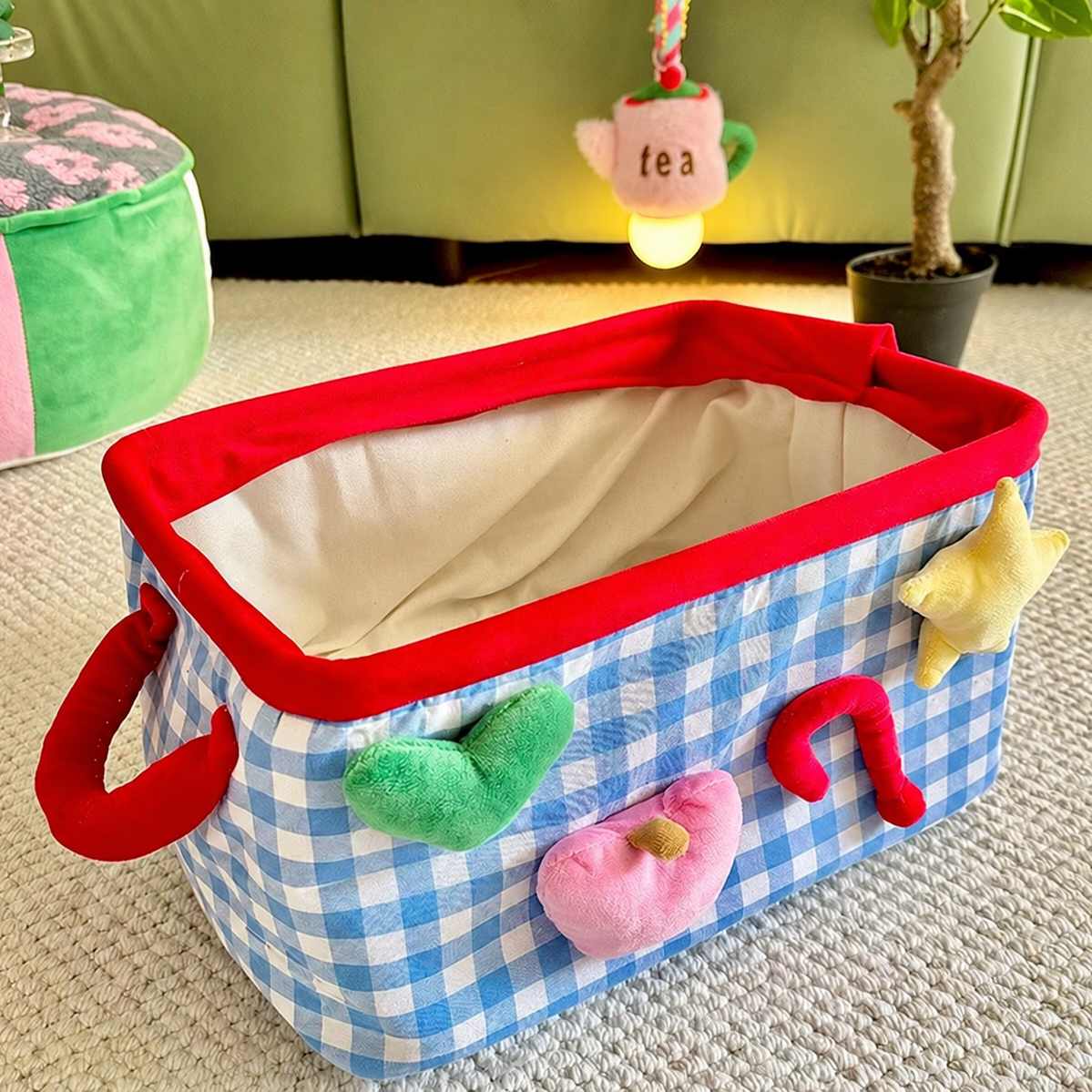 Blue checkered storage basket with handles and colorful front details
