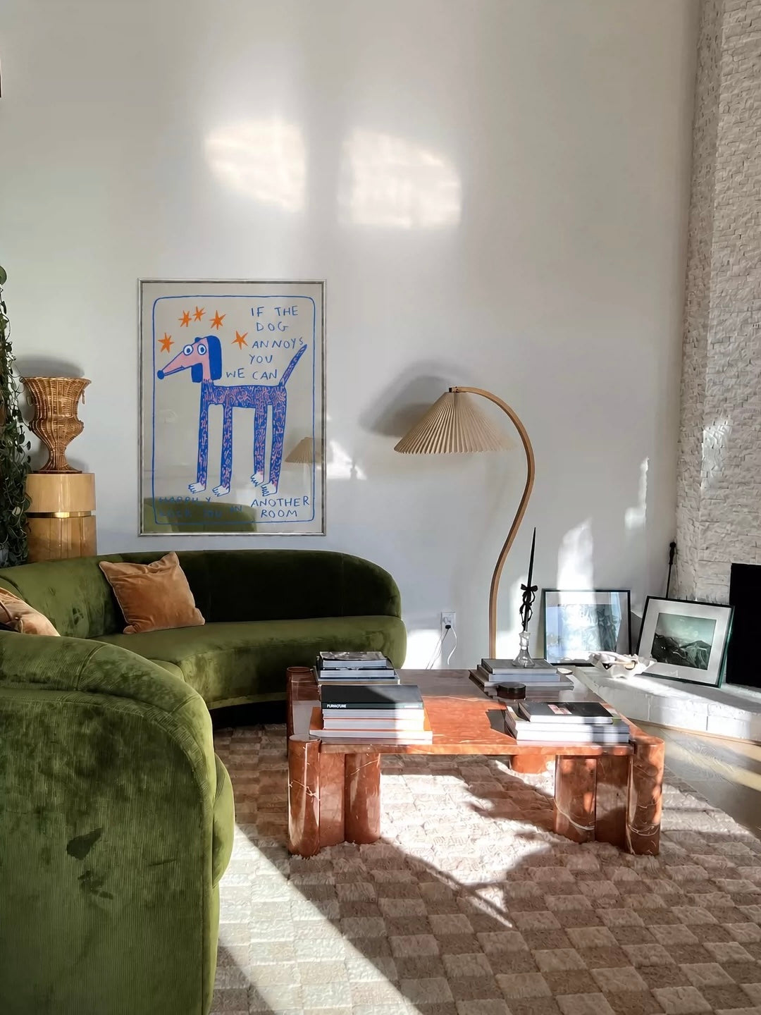 A blue dog mirror is displayed in a living room, with orange stars and handwritten words around the illustrated dog.