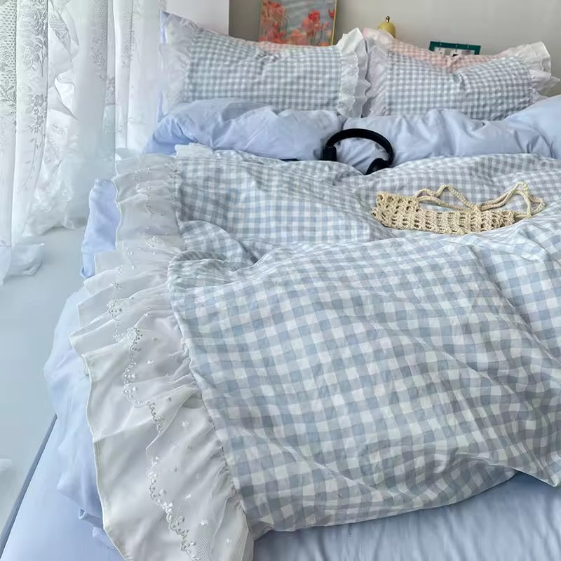 Pink gingham duvet cover with white lace ruffles styled in a coquette bedroom