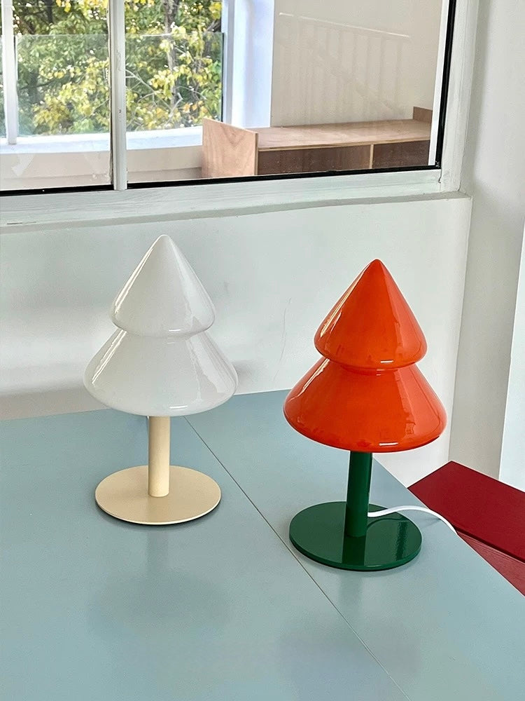 Blue and orange Christmas tree table lamps styled beside a window