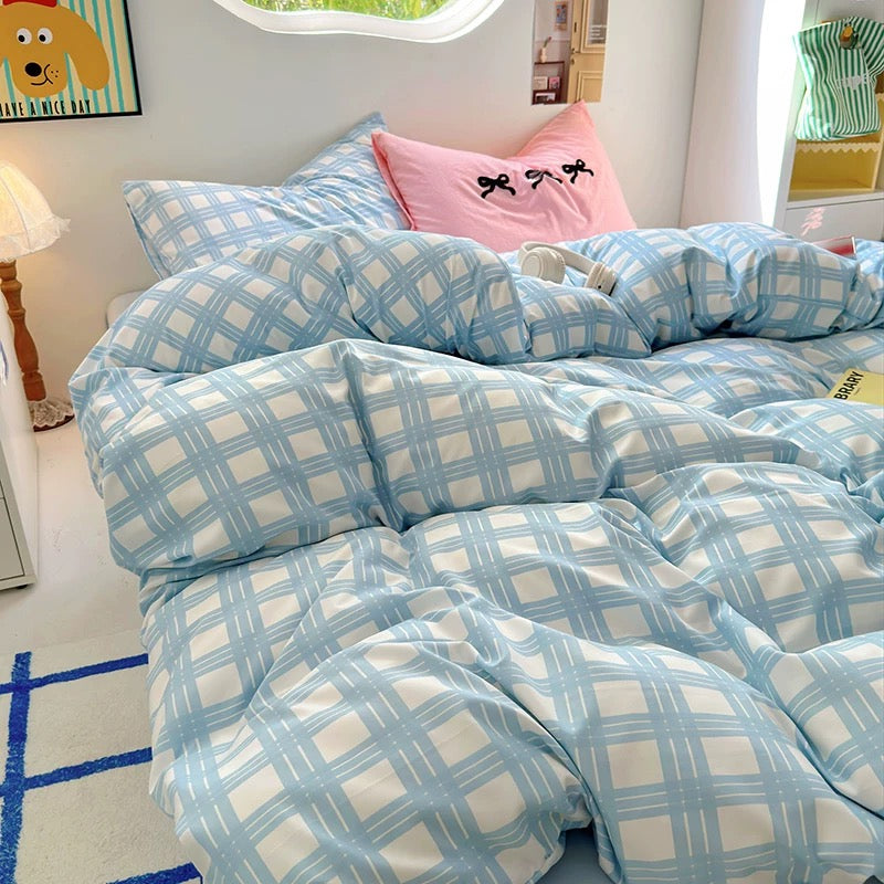 Close-up of the pastel blue plaid bedding set featuring breathable cotton fabric and cozy texture
