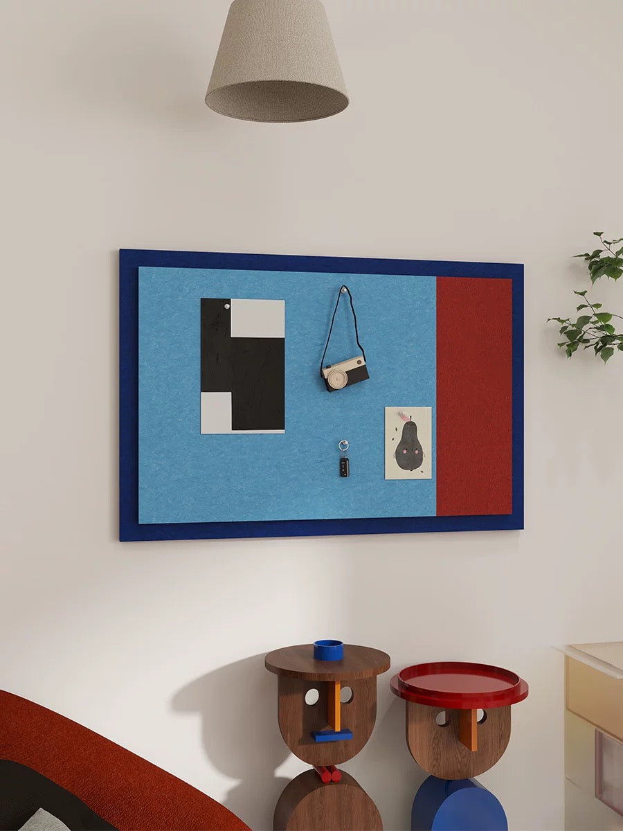Blue and red Bauhaus photo board displayed on a living room wall