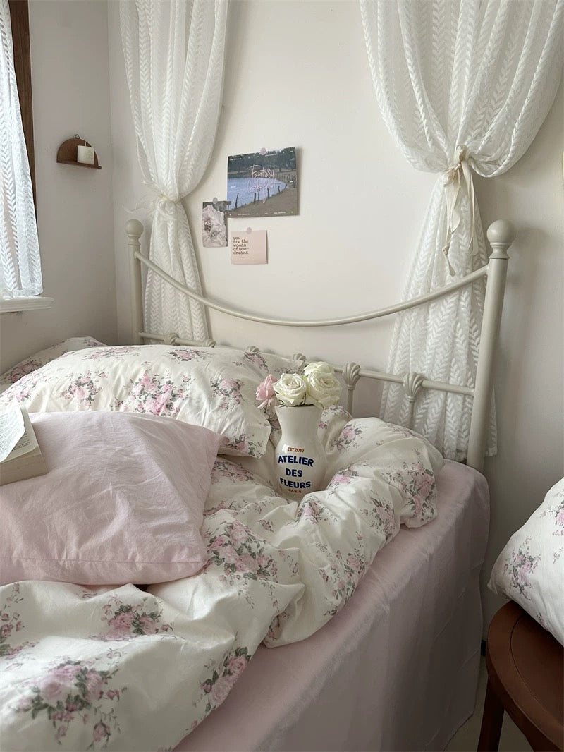 Vintage inspired floral cotton bedding paired with lace textiles creating charming English garden bedroom atmosphere every single day.