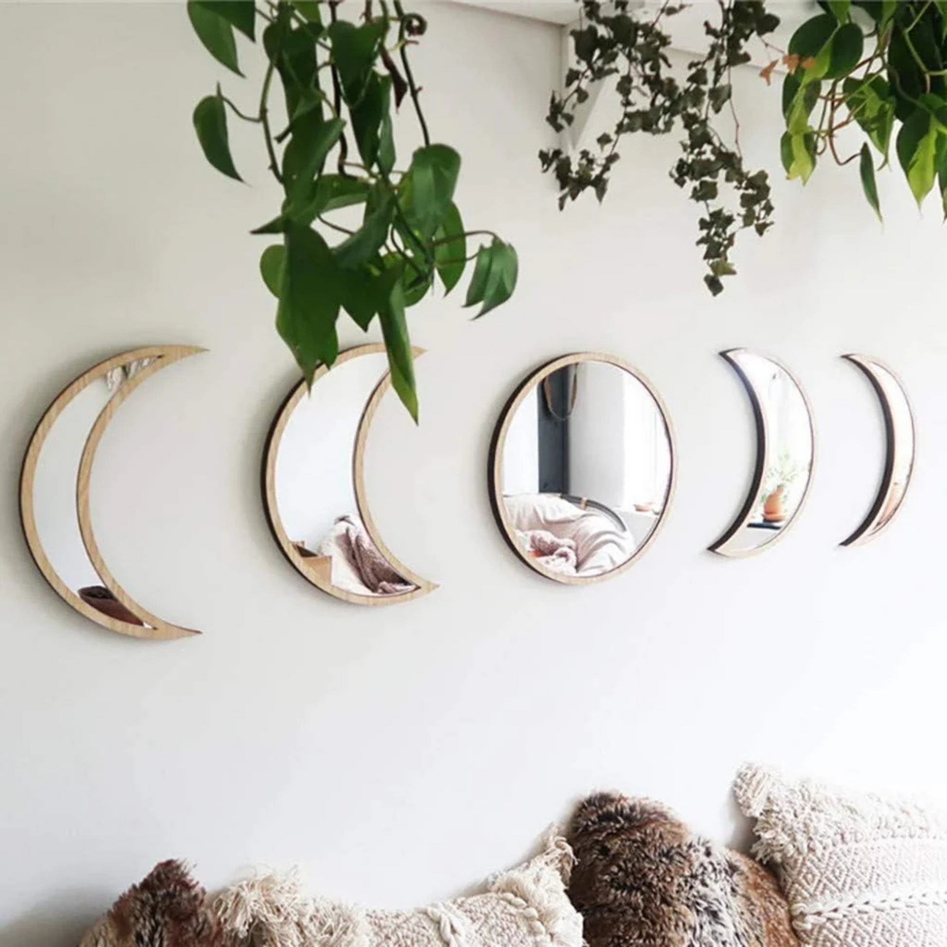 Close-up of acrylic moon mirrors reflecting natural light in a witchcore room
