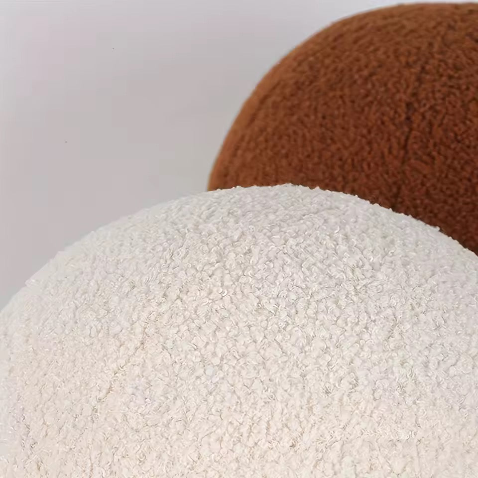 Close-up of textured white and brown spheres on a light gray background