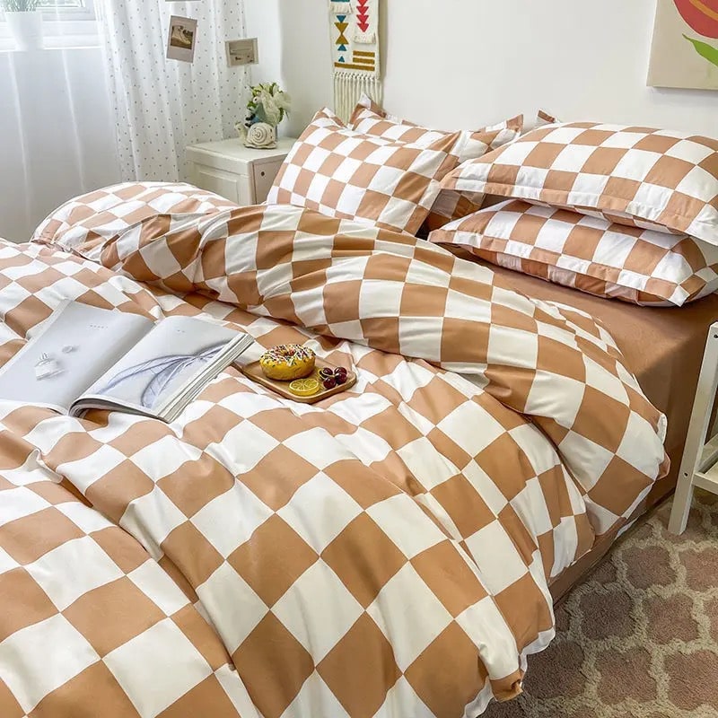 Brown checkerboard bedding set styled on a bed with matching pillowcases