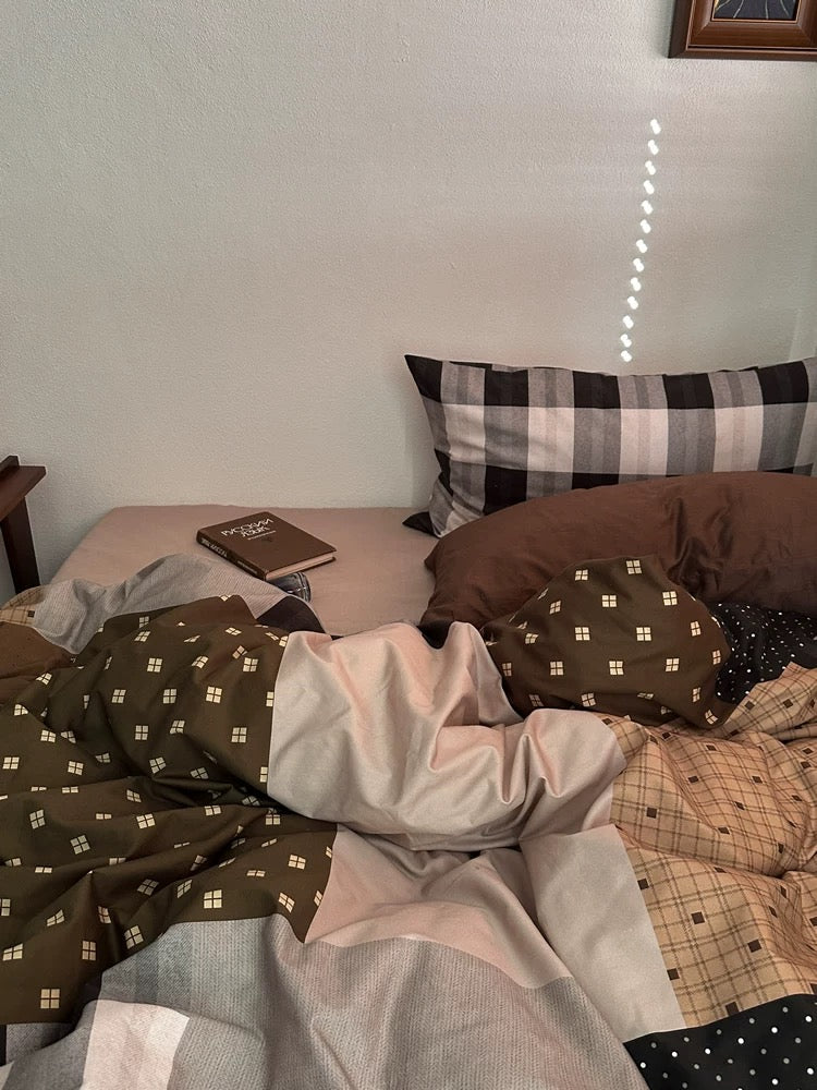 Close-up of brown checkered duvet cover with cream panels and small geometric prints