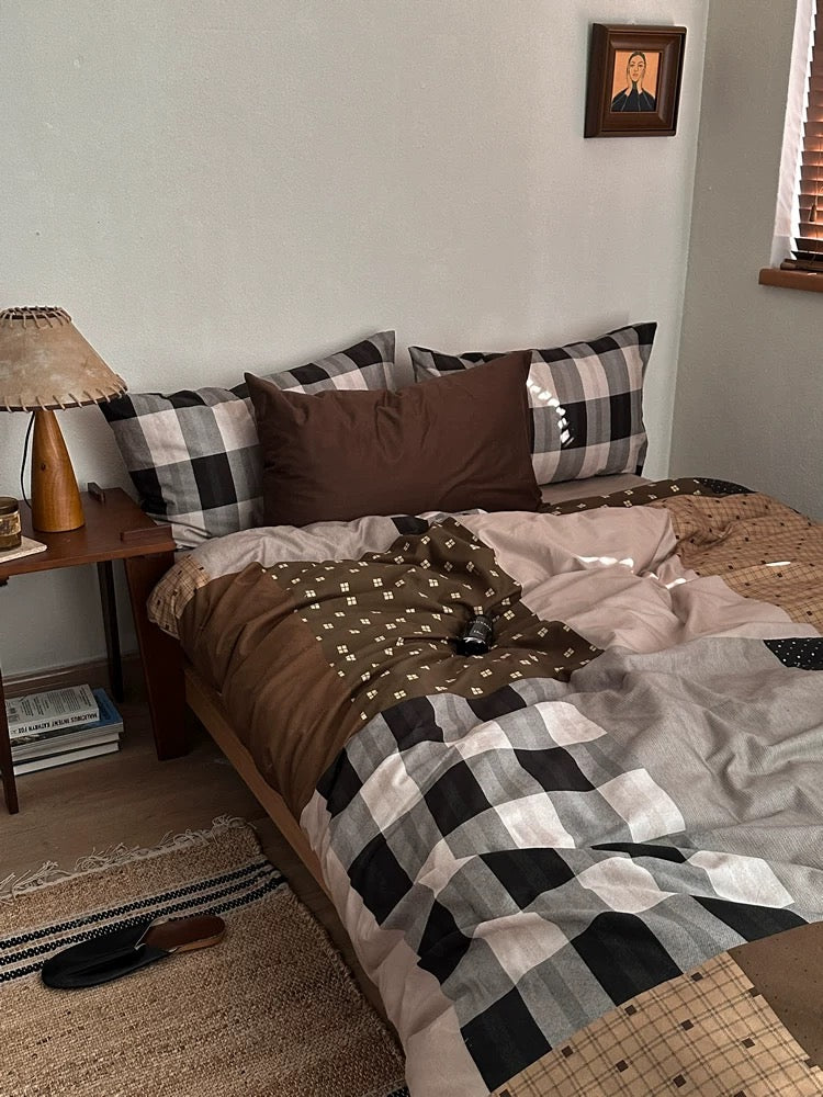 Brown gingham duvet cover styled with checked pillowcases and neutral bedroom decor