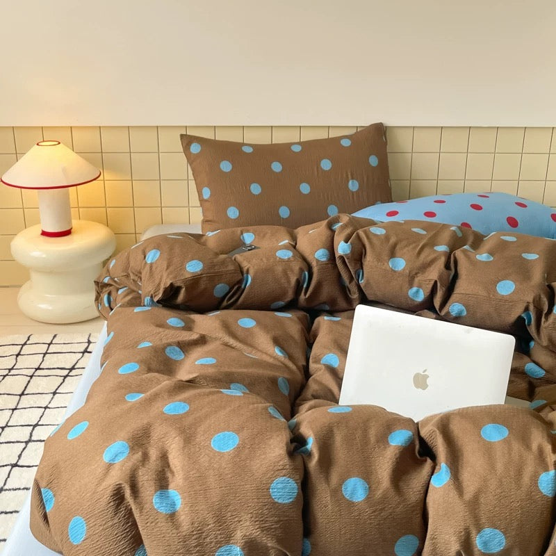 Neutral brown polka dot duvet cover styled in small dorm room cozy aesthetic setup