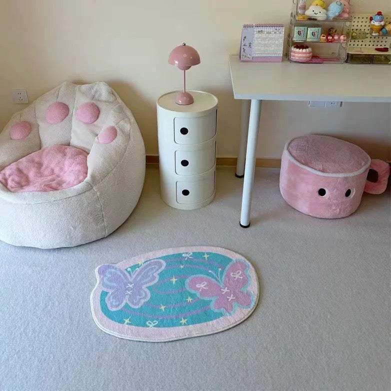 Pastel butterfly bath mat on a light floor beside pink and cream bedroom furniture