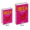 White ceramic pitcher beside bold colorful faux travel books in modern decor.