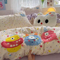 Close-up of embroidered cartoon monster details on kawaii cotton duvet cover.