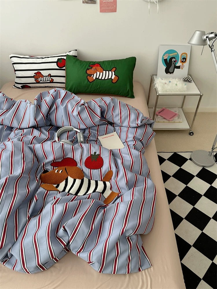Striped bedding with cartoon characters on a bed in a room with a checkered floor.