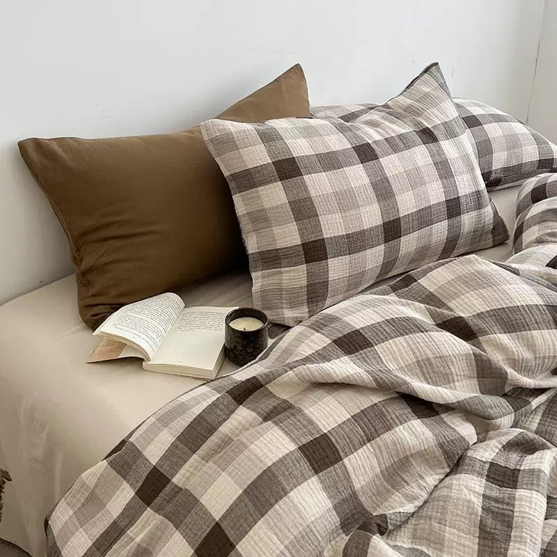 Preppy bedroom styled with a brown plaid duvet cover set and simple warm wood furniture