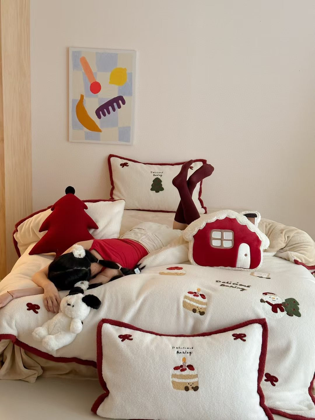 Christmas bedding set styled with a red tree-shaped cushion on the bed