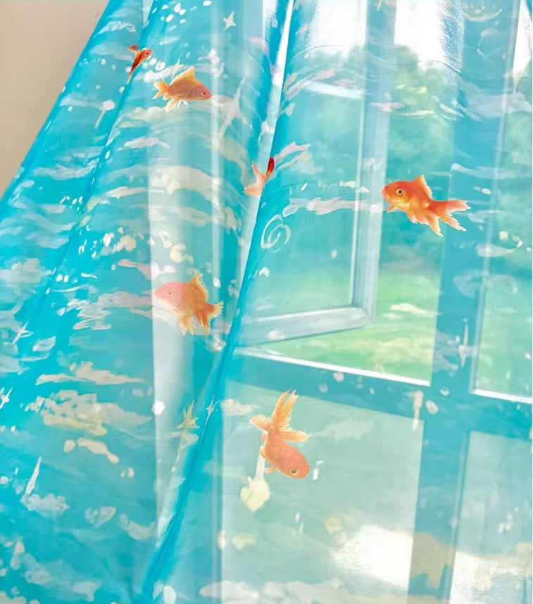 Shower curtain with goldfish design on a blue background