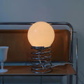 Detail of the stainless steel base, reflecting the lamp's high-quality materials