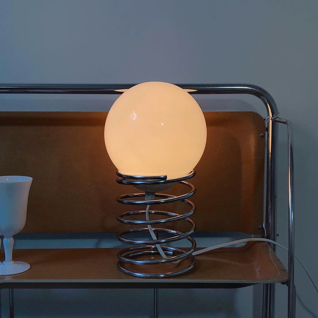 Detail of the stainless steel base, reflecting the lamp's high-quality materials