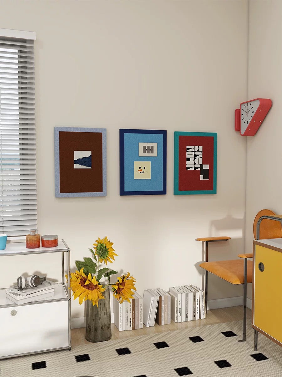 Colorful felt pin boards displayed on a wall with books, flowers, and modern furniture.