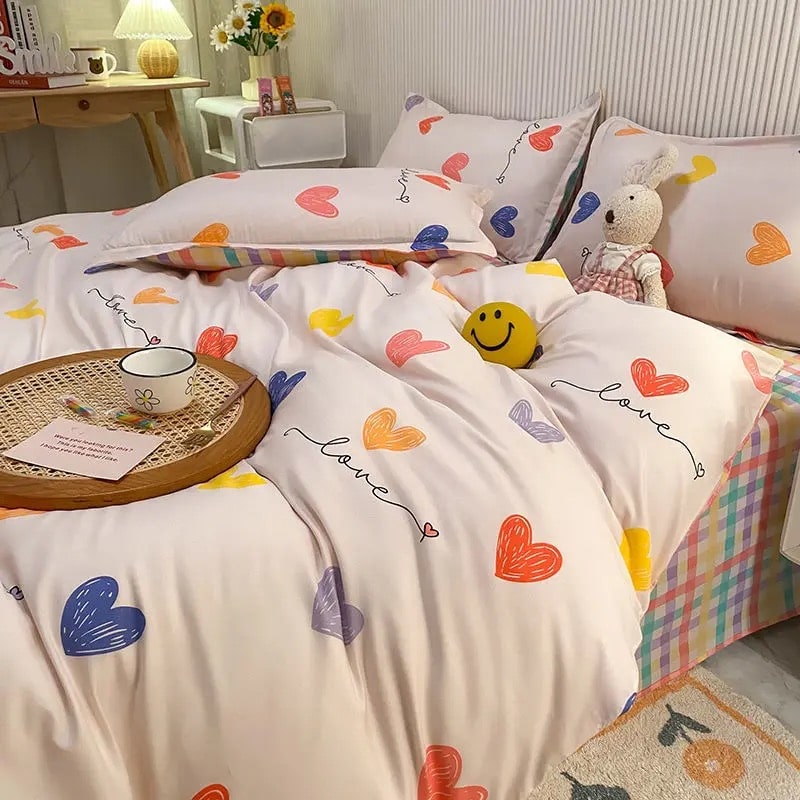 White bedding set with colorful heart print styled on a bed