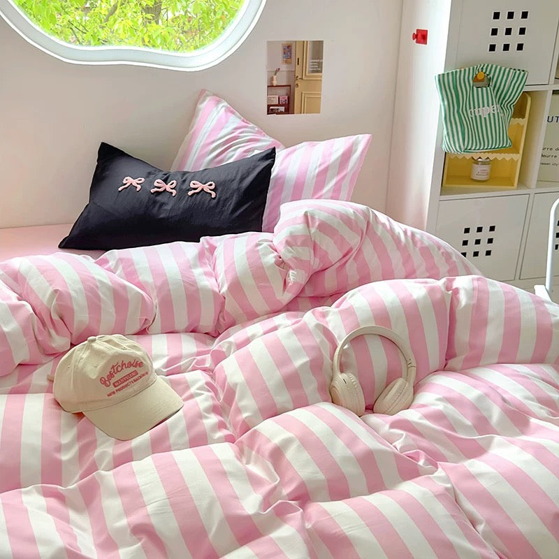 4-piece bedding set including duvet cover, flat sheet, and two pillowcases laid out