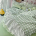 Soft girl aesthetic room with pink plaid bedding and plush decor