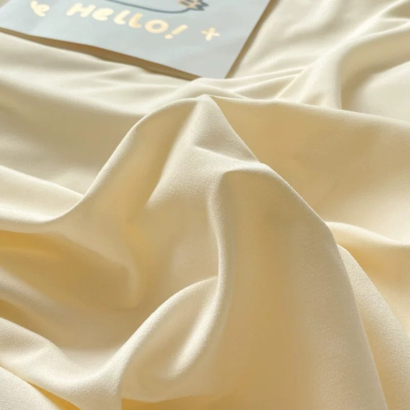 Cozy pastel bedding set featuring blue and cream colors, styled with cute accessories.