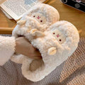 White fluffy slippers with cartoon face design worn by a person on a textured surface.
